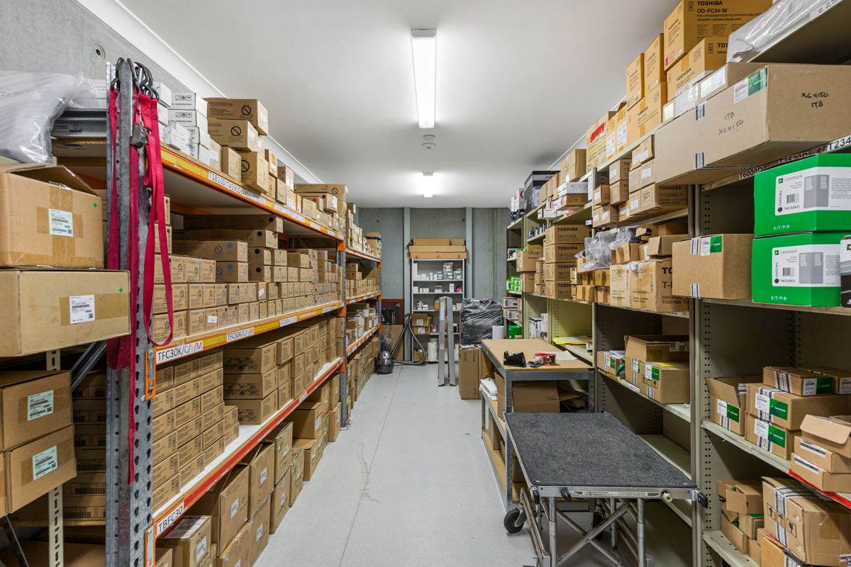 Shelves of toner and parts in the Revolve Print store room